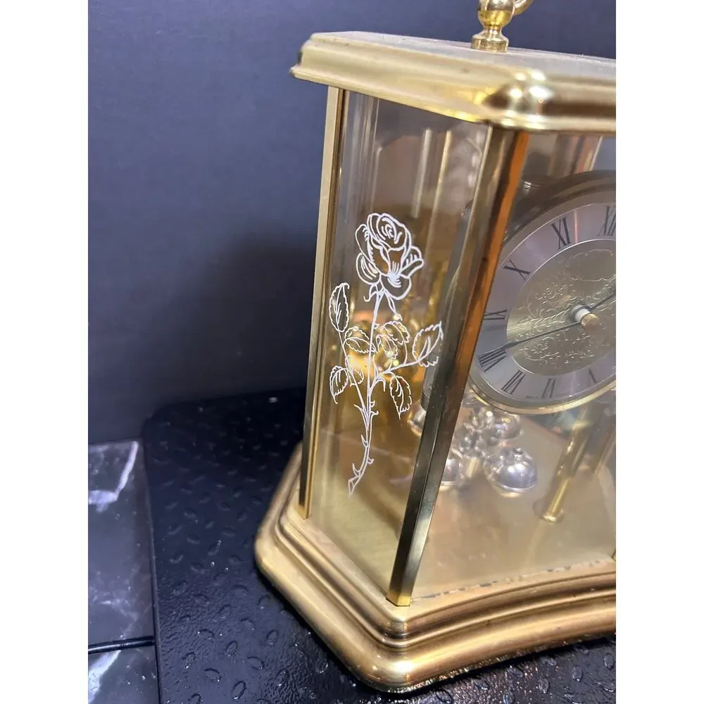 vintage German mantle clock with gold hexagonal glass case and etched roses.